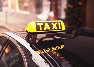 Vehicle with "Taxi" light/sign on its roof
