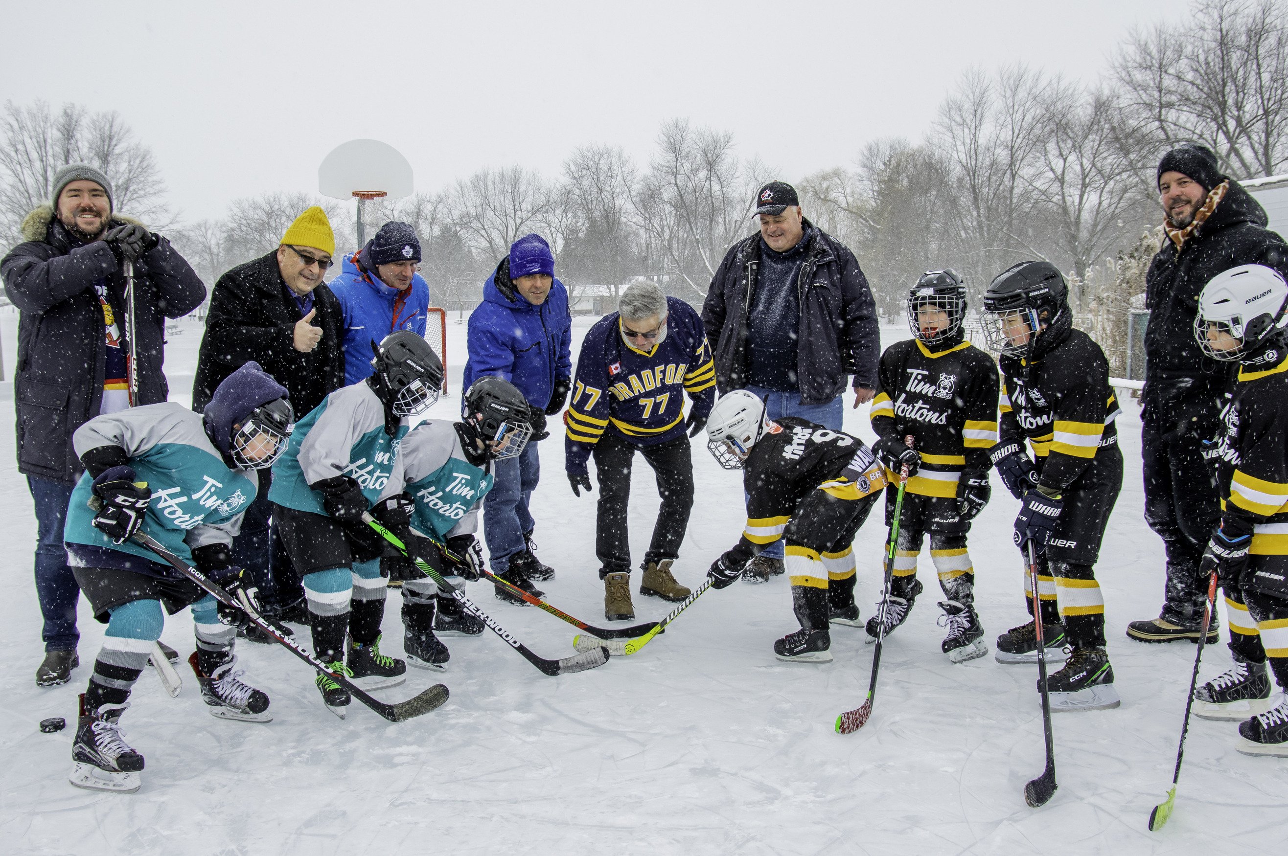 Members of BWG council and children playing hockey outside