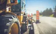 Yellow tractor on a roadwork construction site