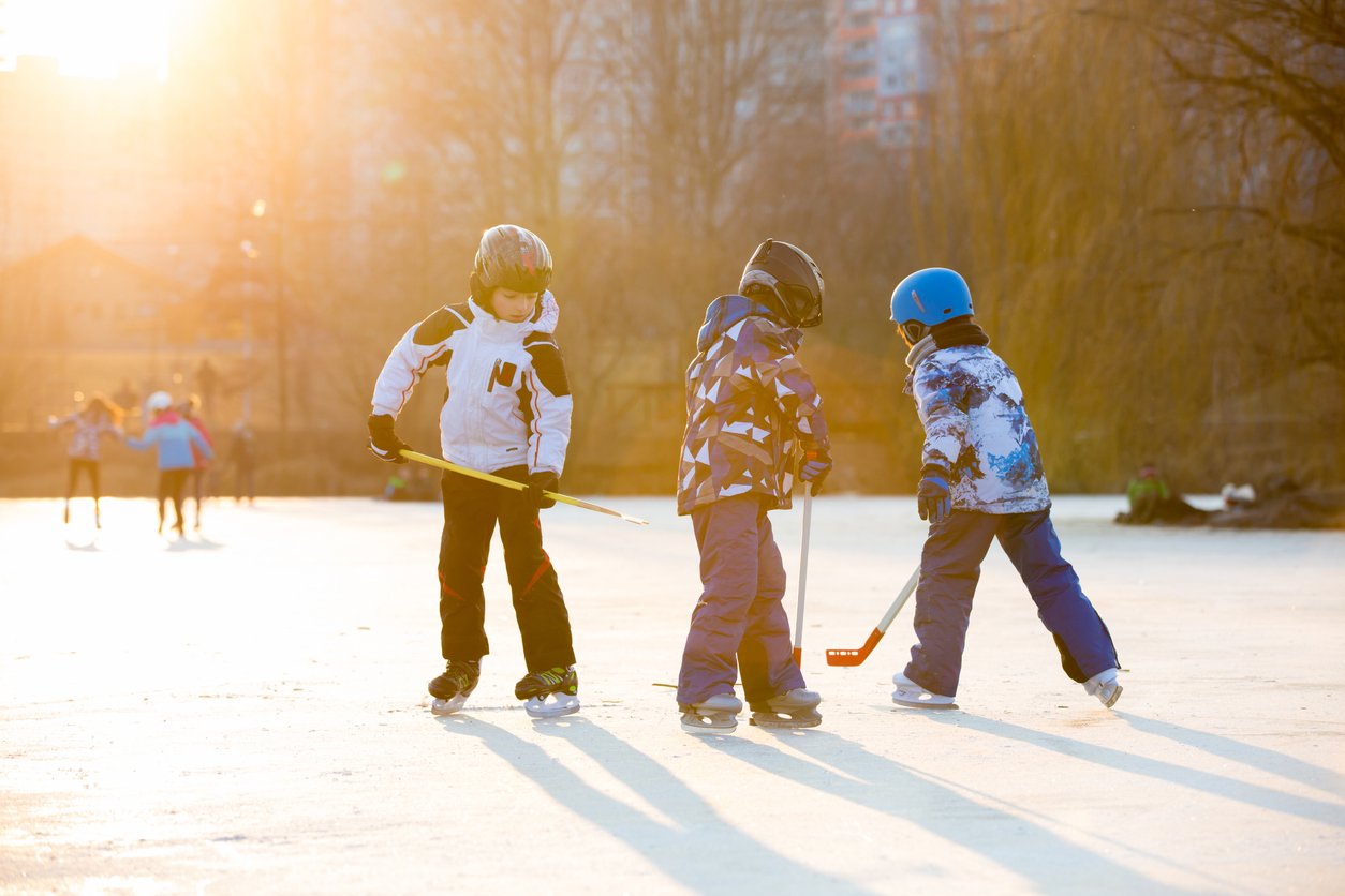 image of kids playing hockey on outdoor rink