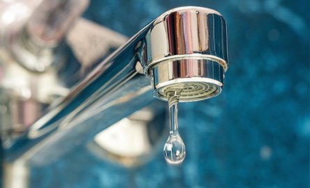 Water dripping from a leaky faucet