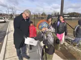 Mayor Leduc giving out On the Move booklets at local school