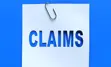 Piece of paper with a paper clip, and "Claims" cut out