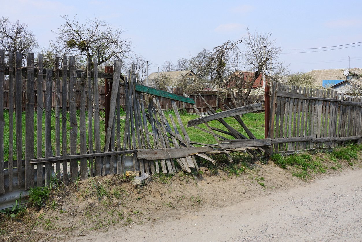 Unkept property with broken fence