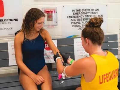 lifeguard performing first aid