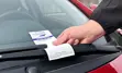 Photo of BWG Enforcement Officer placing a Penalty Notice on the windshield of a vehicle