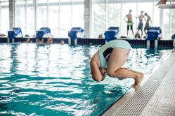 child rolling into water
