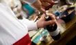 Photo of bartender at private event, opening a bottle of wine