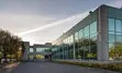 Photo of office building exterior and parking lot