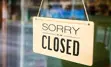 Sign on retail store reading "sorry, we are closed"